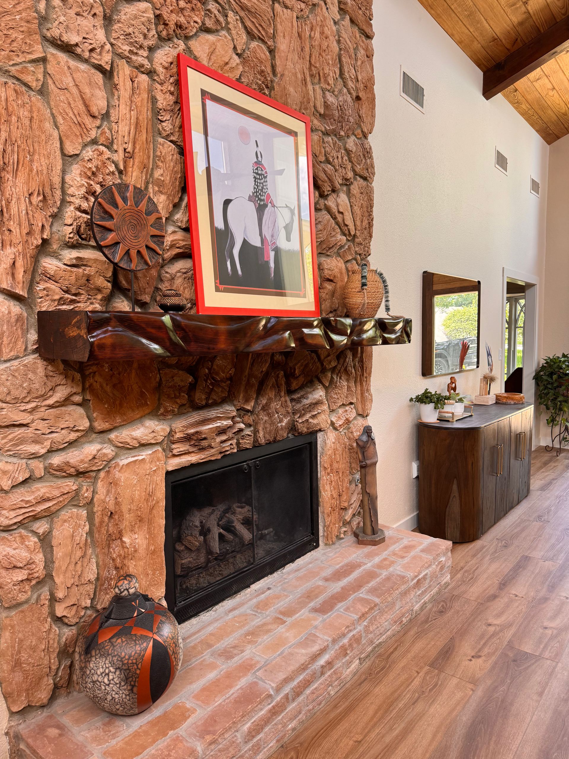Living room with stone fireplace and custom wood mantle